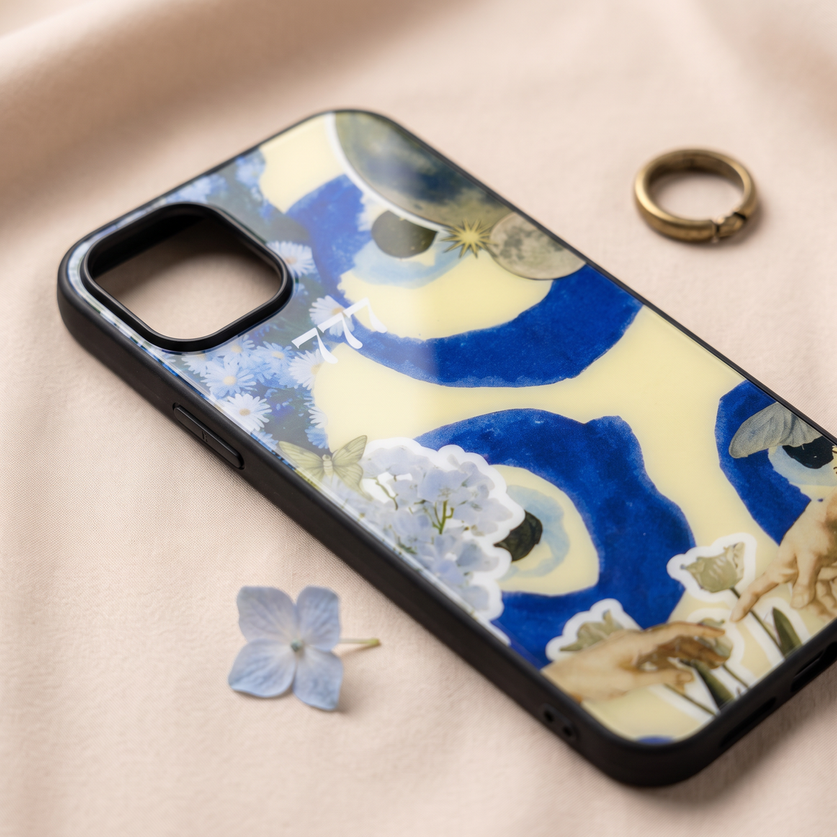 Close-up of 777 aesthetic collage phone cover showing glossy print and black camera rim